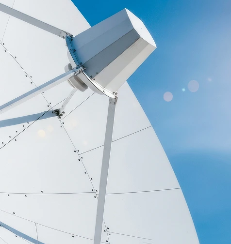 Large white satellite dish against a blue sky - Illustrative image for Telecom industry AI-enhanced solutions.